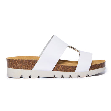 White Plakton Clarissa sandal with two wide leather straps connected by a gold metal detail, cork and Memory Foam footbed, and a white lightweight sole.